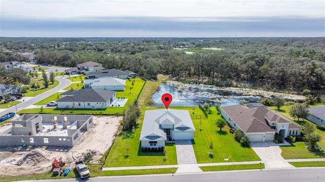 drone / aerial view with a residential view and a wooded view