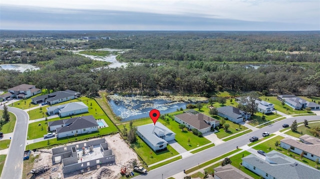 aerial view with a water view, a forest view, and a residential view