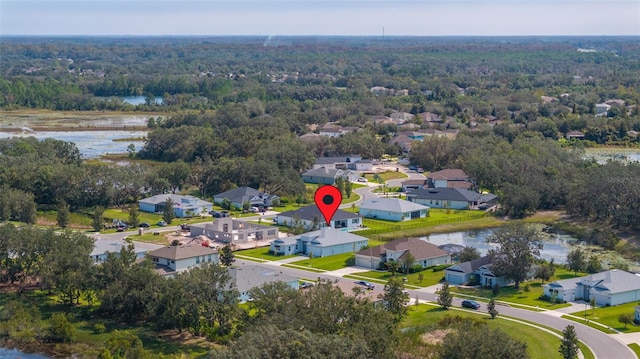 birds eye view of property featuring a water view, a residential view, and a view of trees