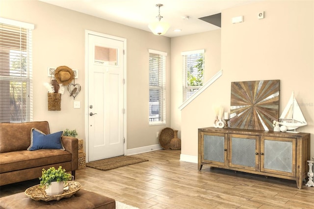 foyer entrance featuring wood finished floors and baseboards