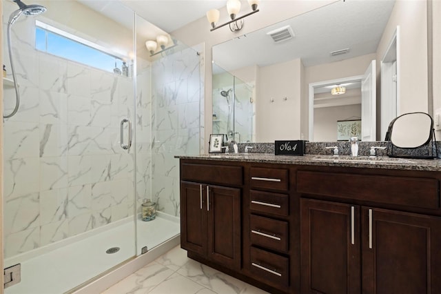 full bathroom featuring visible vents, marble finish floor, a marble finish shower, and a sink
