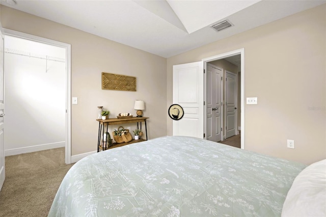 bedroom featuring carpet floors, visible vents, lofted ceiling, and baseboards