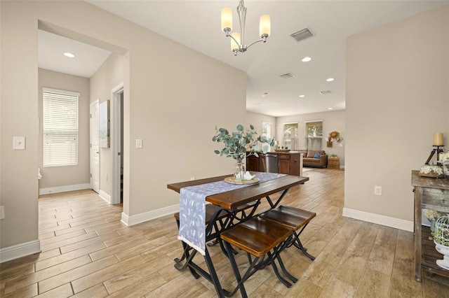 dining room with light wood-type flooring, baseboards, and visible vents