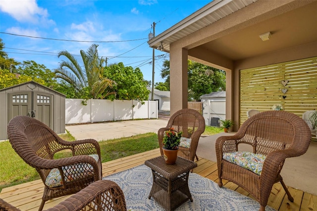 view of patio with a fenced backyard, an outbuilding, and a storage shed
