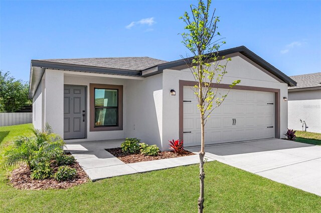 single story home featuring a front lawn and a garage