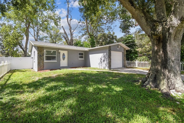 view of front of home with a front yard and a garage