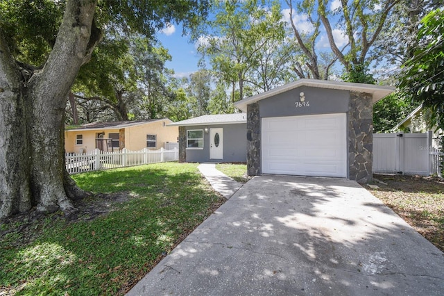 single story home with a front yard and a garage