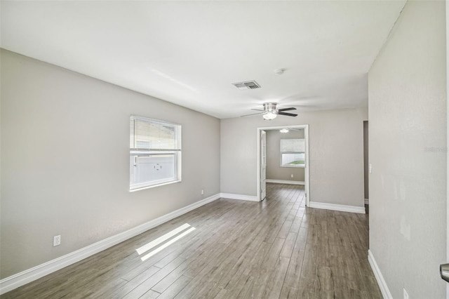 empty room with hardwood / wood-style flooring and ceiling fan