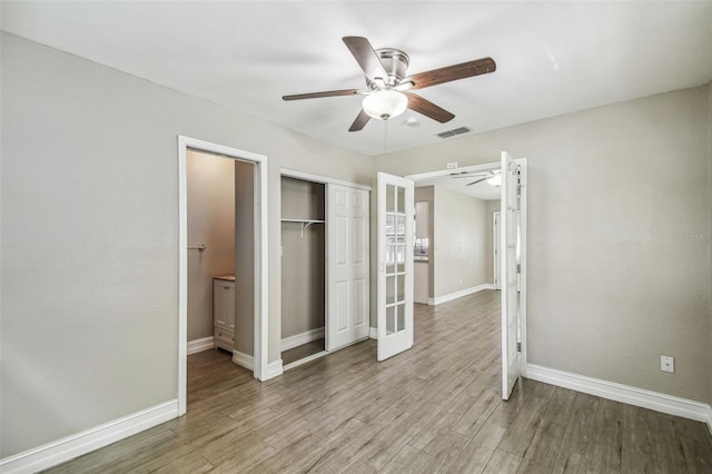 unfurnished bedroom featuring light hardwood / wood-style floors, a closet, and ceiling fan