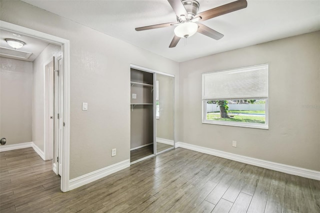 unfurnished bedroom featuring a closet, ceiling fan, and hardwood / wood-style flooring