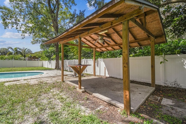 exterior space with a gazebo, a fenced in pool, and ceiling fan