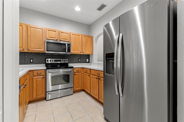 214 Cape Harbour Loop Unit 105, Bradenton, FL 34212 - kitchen featuring stainless steel appliances, light countertops, light tile patterned floors, backsplash, and recessed lighting
