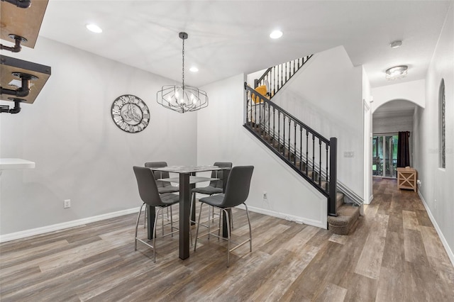 214 Cape Harbour Loop Unit 105, Bradenton, FL 34212 - dining area featuring arched walkways, wood finished floors, stairs, baseboards, and recessed lighting