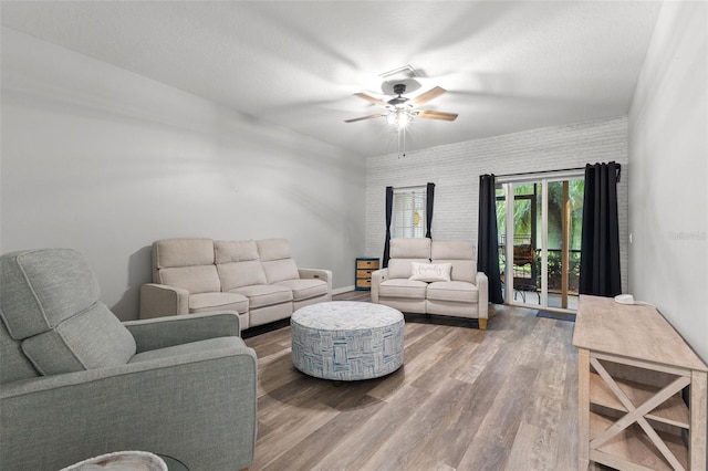 214 Cape Harbour Loop Unit 105, Bradenton, FL 34212 - living area featuring ceiling fan, wood finished floors, baseboards, and wallpapered walls