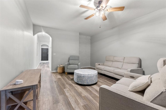 214 Cape Harbour Loop Unit 105, Bradenton, FL 34212 - living room featuring arched walkways, a ceiling fan, wood finished floors, and baseboards
