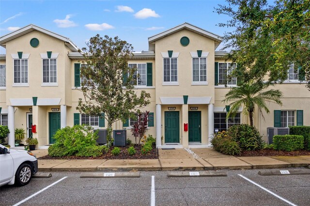 214 Cape Harbour Loop Unit 105, Bradenton, FL 34212 - townhome / multi-family property featuring stucco siding, uncovered parking, and central air condition unit