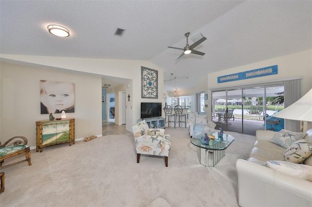 carpeted living room featuring ceiling fan and vaulted ceiling