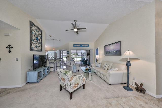 living room featuring ceiling fan, a textured ceiling, lofted ceiling, and light colored carpet