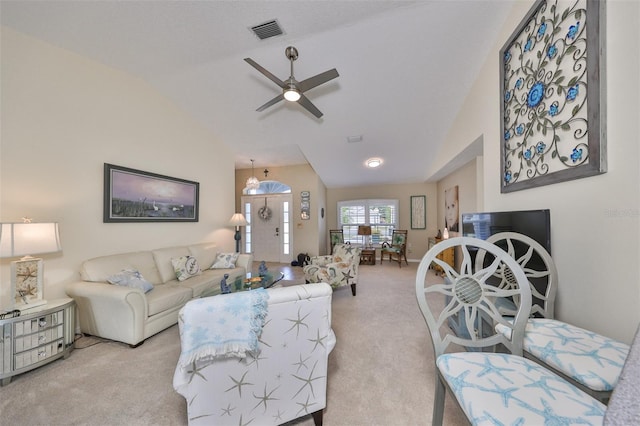 carpeted living room with ceiling fan and lofted ceiling