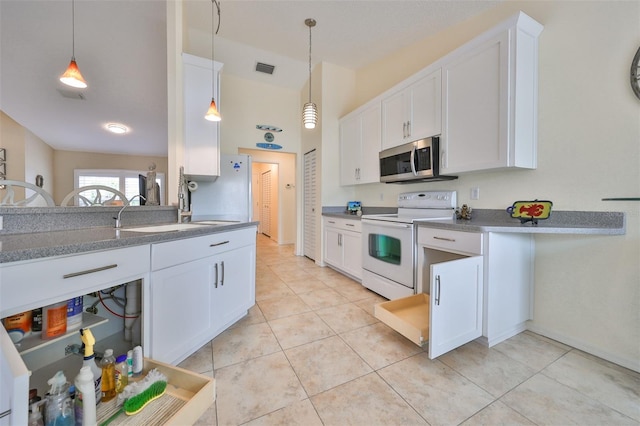 kitchen featuring white electric range oven and white cabinets