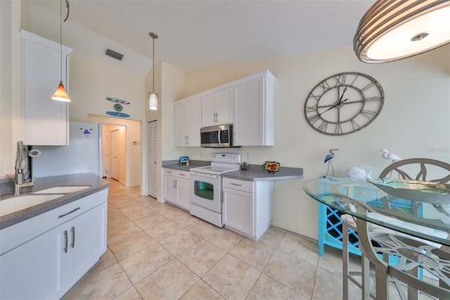 kitchen featuring lofted ceiling, white cabinets, white electric range oven, and sink