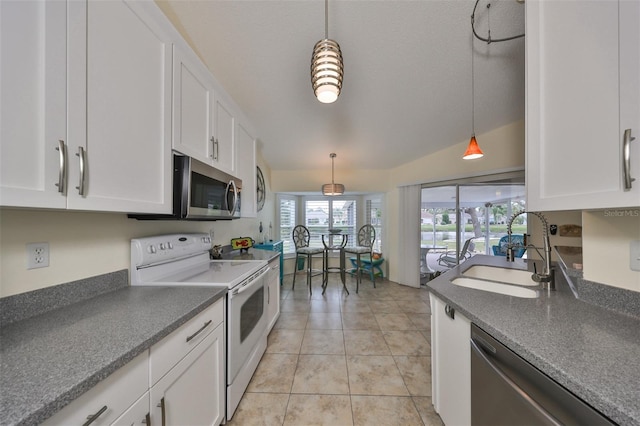 kitchen featuring light tile patterned floors, white cabinetry, sink, pendant lighting, and stainless steel appliances