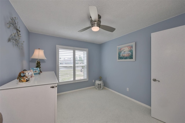 interior space featuring a textured ceiling and ceiling fan