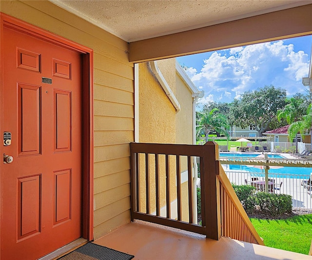 doorway to property with a community pool