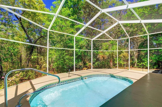 view of swimming pool featuring a patio area and a lanai