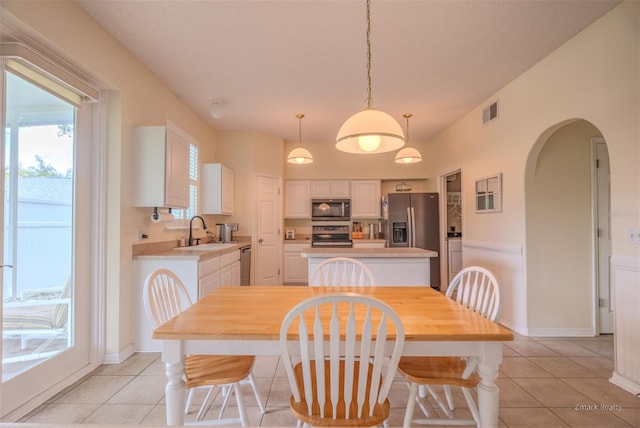 tiled dining area featuring sink