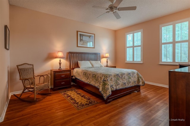 bedroom featuring a textured ceiling, hardwood / wood-style flooring, and ceiling fan