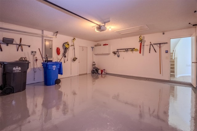 garage featuring electric panel and a garage door opener