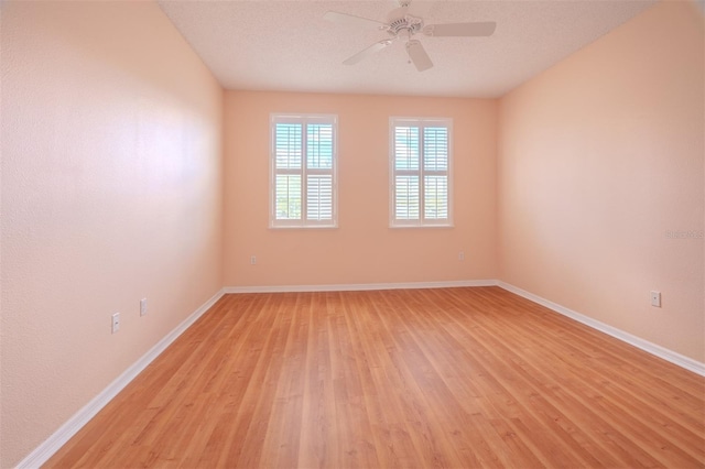 unfurnished room with a textured ceiling, light hardwood / wood-style flooring, and ceiling fan