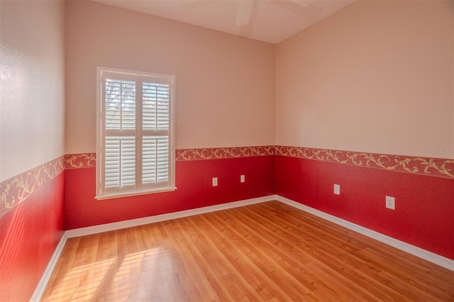 spare room featuring wood-type flooring