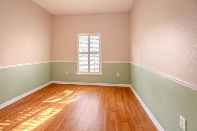 unfurnished room with hardwood / wood-style flooring