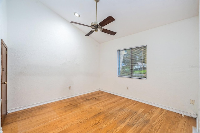 empty room with wood-type flooring, ceiling fan, and lofted ceiling