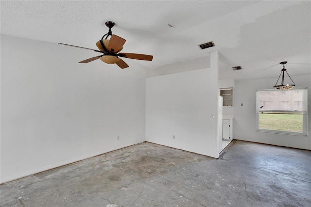 unfurnished room with ceiling fan, a textured ceiling, and concrete flooring