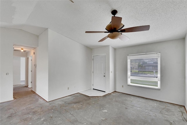 spare room featuring ceiling fan, a textured ceiling, and lofted ceiling