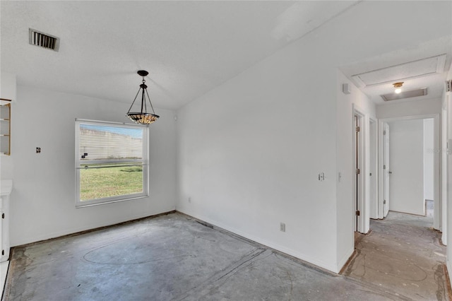 unfurnished dining area with a textured ceiling