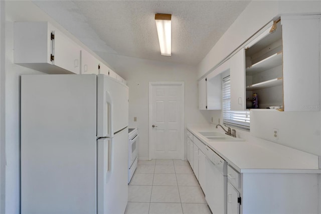 kitchen with sink, vaulted ceiling, white cabinets, a textured ceiling, and white appliances