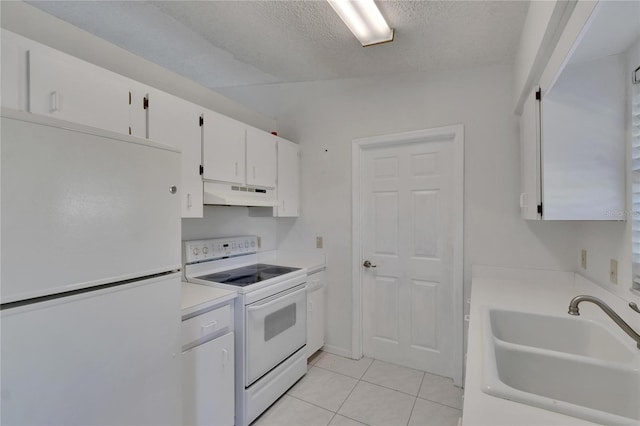 kitchen featuring sink, light tile patterned floors, white cabinetry, a textured ceiling, and white appliances