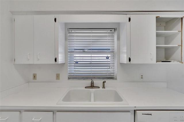 kitchen with sink, white cabinets, and dishwasher