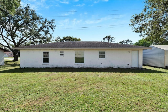 back of house with a lawn