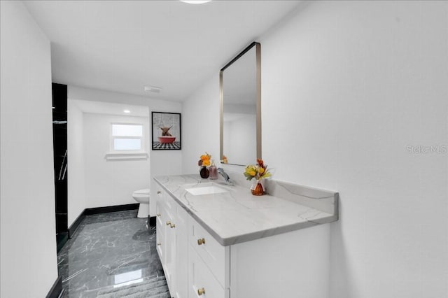 bathroom featuring vanity and toilet