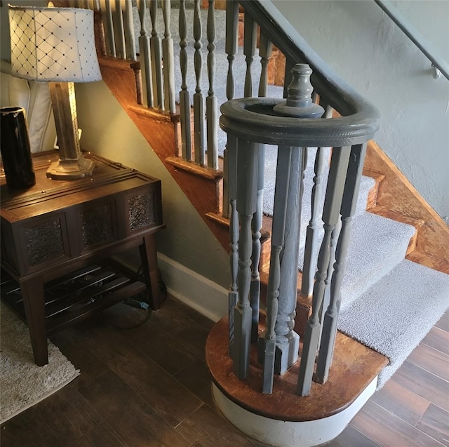 stairway featuring wood-type flooring