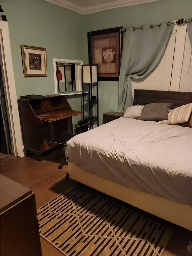 bedroom with ornamental molding and tile patterned flooring