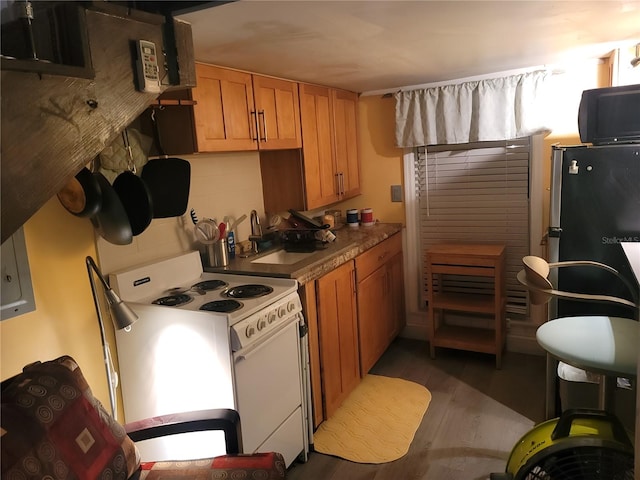 kitchen featuring white electric stove, dark hardwood / wood-style flooring, and tasteful backsplash