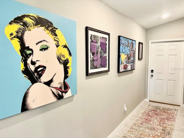 tiled foyer featuring lofted ceiling