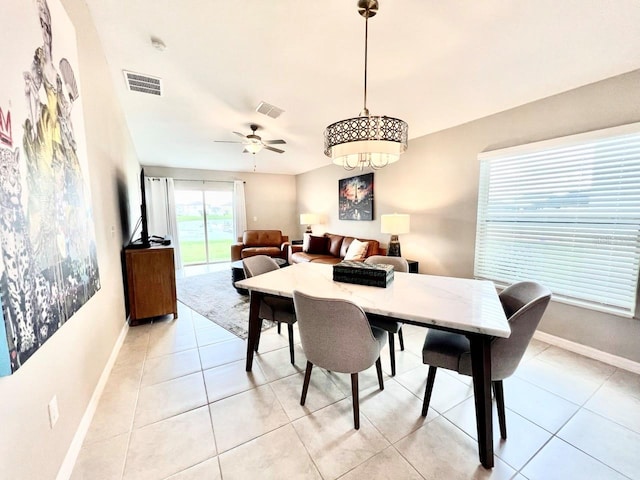 tiled dining space featuring ceiling fan