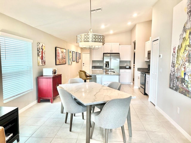 dining area with lofted ceiling and light tile patterned floors